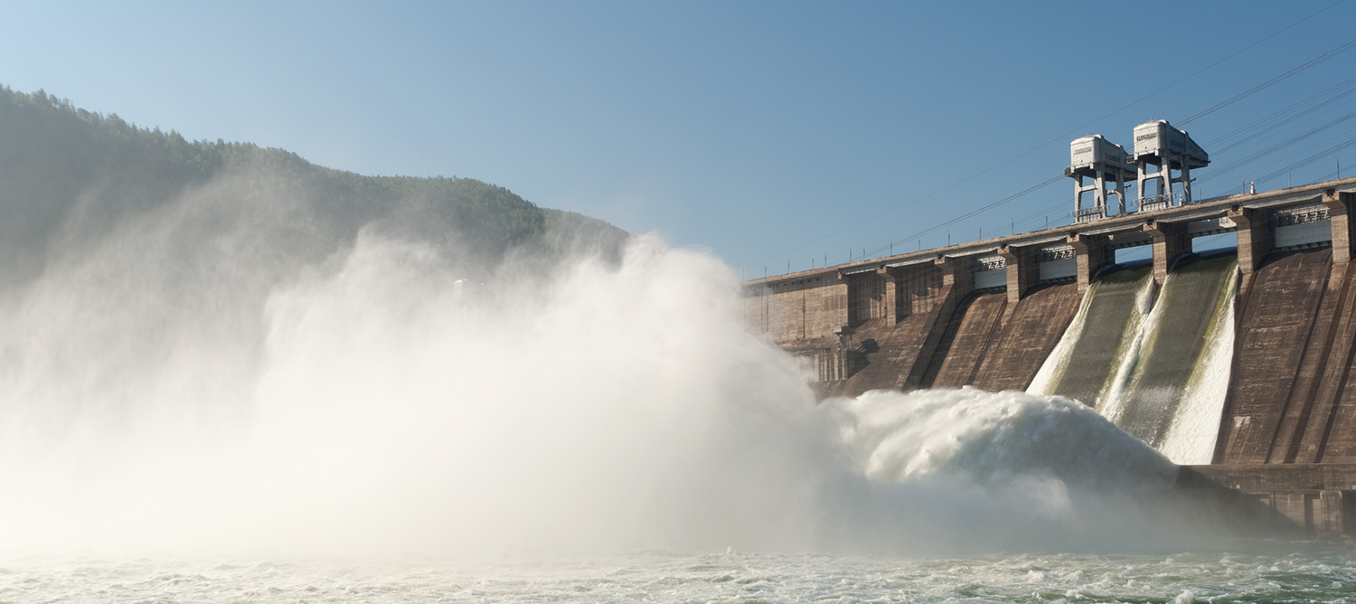 scenographic image of a hydroelectric power plant, blue skies and water